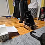 Yin joined the competition — help win amazing prizes! black_cat, cat, cardboard_box, tiny_box, hardwood_floor, gray_rug, tail, green_eyes, whiskers, living_room, vacuum_cleaner, laundry_basket, dumbbell, door, tower_fan, packing_box, pet, home_interior, cozy, playful