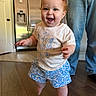 Eloise joined the competition — help win amazing prizes! toddler, child, indoor, smiling, walking, barefoot, tshirt, shorts, red_hair, person, floor, jeans, adult, home, refrigerator, cabinet, wooden_floor, happy, cute, family