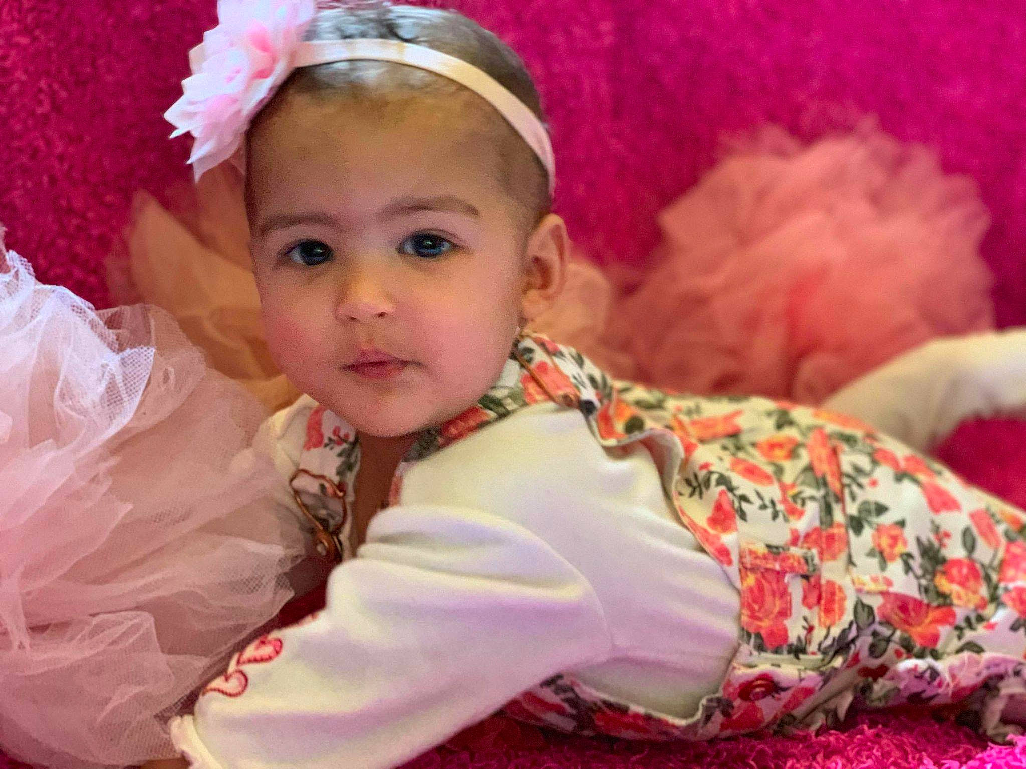 Sereniti is registered to the contest to win money with this photo: baby, cheek, child, eye, face, fashion_accessory, hair_accessory, happy, head, headband, headgear, headpiece, nose, person, pink, smile, toddler, tradition