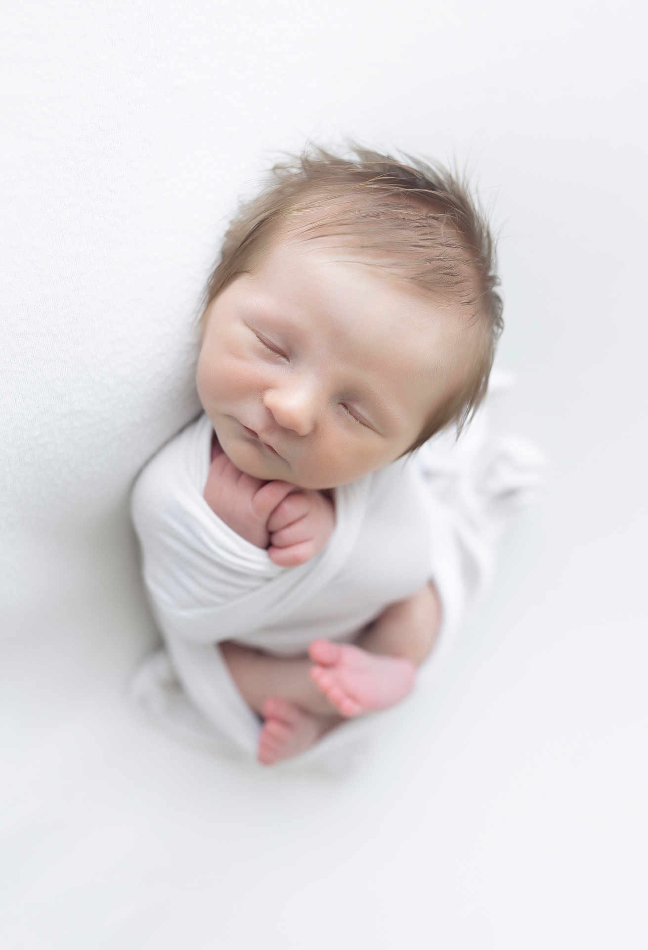 Teddy is registered to the contest to win money with this photo: newborn, baby, sleeping, wrapped, white_blanket, peaceful, soft, infant, cute, portrait, tiny, hands, feet, skin, face, closeup, studio, photography, calm, rest