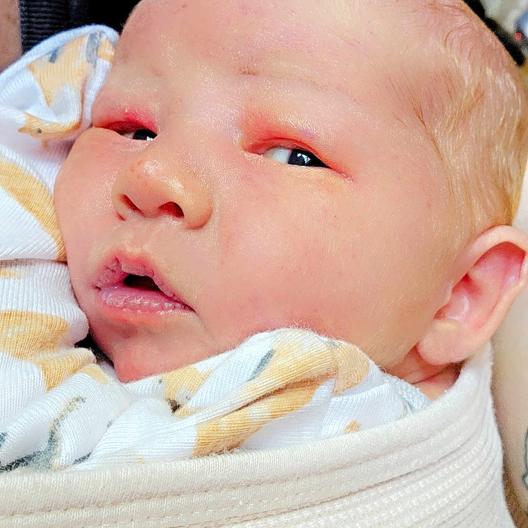 Kyle is registered to the contest to win money with this photo: baby, blanket, bodypart, face, finger, hand, head, mouth, newborn, person, photography, portrait, quilt, sleeping, towel