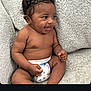 baby, smiling, diaper, curly_hair, sitting, couch, indoor, child, cute, infant, happy, skin, person, portrait, toddler, expression, relaxed, comfort, young, furniture