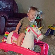 Axil joined the competition — help win amazing prizes! toddler, child, indoor, living_room, toy, inflatable_unicorn, carpet, furniture, sofa, table, playtime, cute, smiling, colorful, plastic, young_child, person, home, unicorn, play