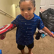 Brandon joined the competition — help win amazing prizes! child, boy, braided_hair, blue_shirt, champion_brand, toy_shield, barefoot, carpet, indoor, stairs, watch, black_shorts, wall, door, clothes, plastic_bag, home, person, standing, playful