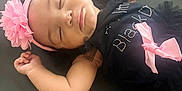 Braelynn is registered to the contest to win money with this photo: baby, sleeping, girl, headband, pink_flower, black_dress, bow, infant, peaceful, closeup, indoor, soft_light, portrait, child, cute, adorable, resting, toddler, young_child, face