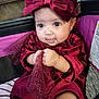 baby, infant, child, red_dress, headband, bow, stroller, tulle, sparkle, cute, chubby_cheeks, clothing, portrait, indoor, hand, face, person, sitting, expression, comfort