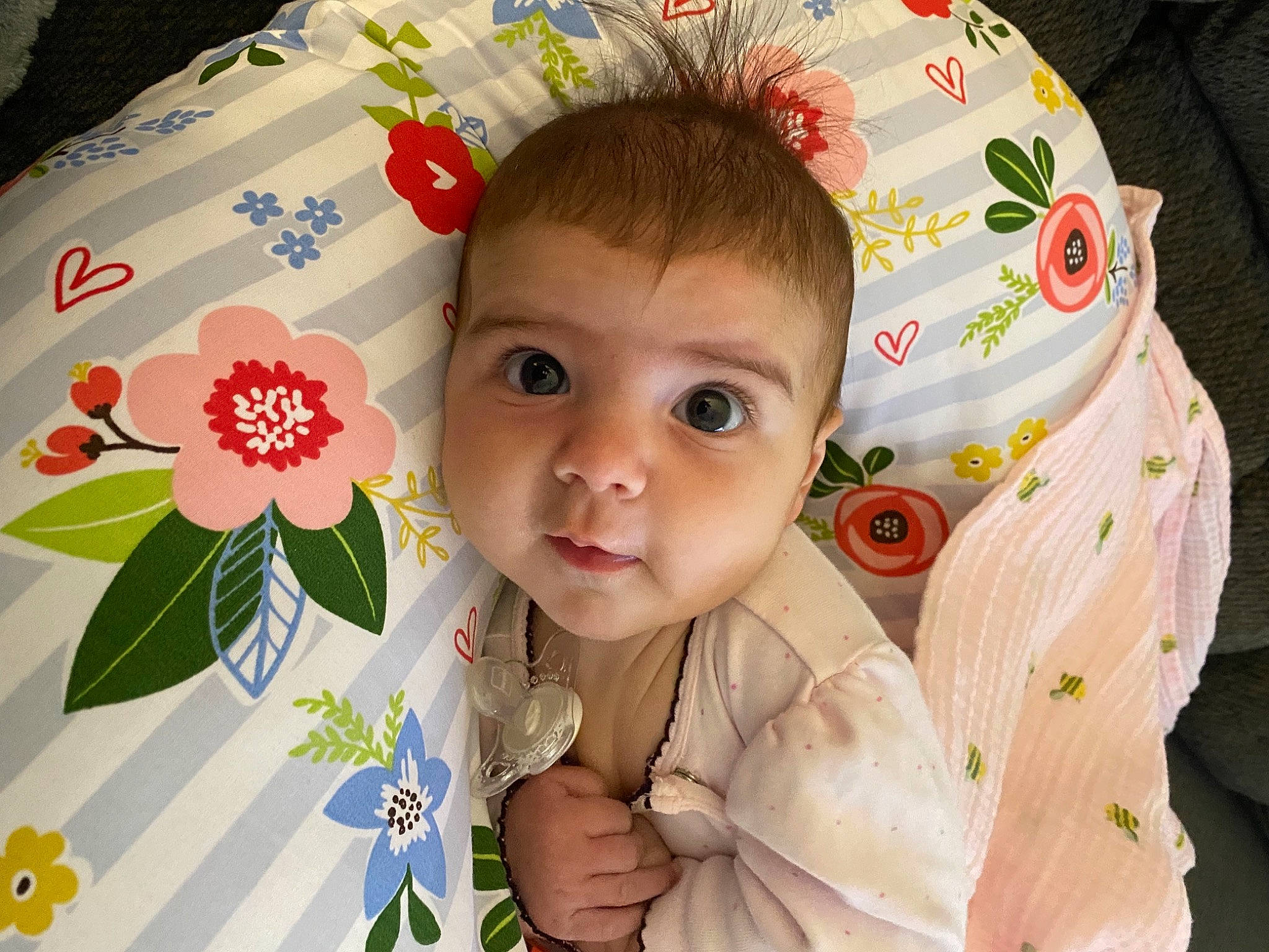 Margot is registered to the contest to win money with this photo: baby, baby_products, baby_safety, baby_toddler_clothing, cheek, child, eye, happy, iris, linens, pattern, person, petal, pink, product, room, skin, sleeve, smile, textile