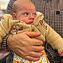 Archie joined the competition — help win amazing prizes! baby, infant, hand, knitted_sweater, animal_patch, checkered_shirt, person, holding, cute, face, clothing, pattern, portrait, indoor, warm, newborn, expression, people, soft, child
