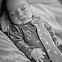 baby, sleeping, pajamas, hand, face, infant, blanket, cozy, soft, monochrome, portrait, peaceful, cute, child, resting, indoor, newborn, comfort, relaxation, toddler