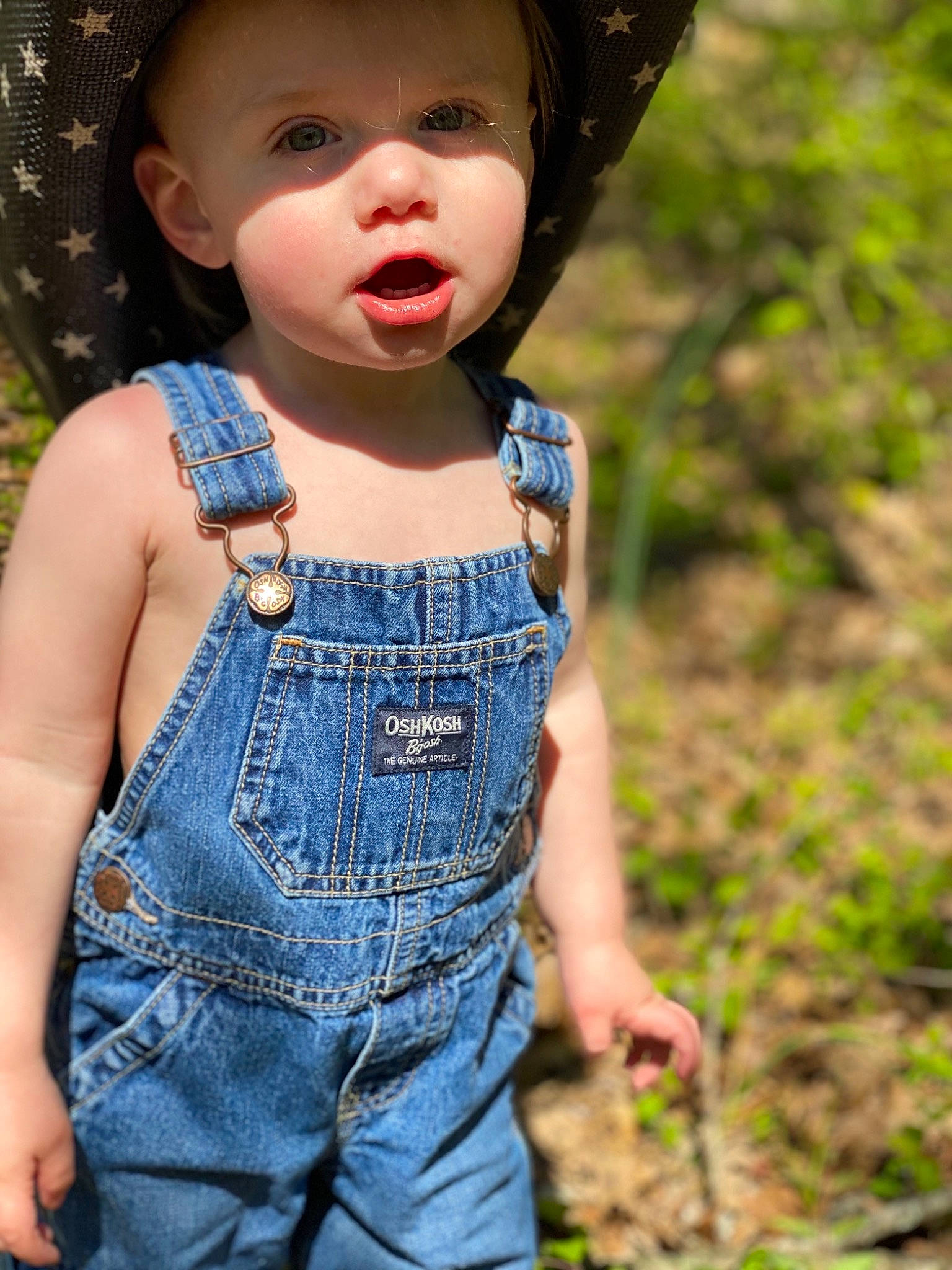 Greyson is registered to the contest to win money with this photo: child, clothing, denim, grass, headgear, headwear, jeans, overall, person, smile, textile, toddler