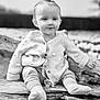 baby, child, infant, knitted_sweater, pacifier, socks, wooden_bench, outdoor, portrait, black_and_white, cute, smiling, young_child, nature, cozy, sitting, face, head, expression, peaceful