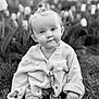 baby, child, grass, tulips, flower, knitwear, cardigan, cute, smile, outdoor, nature, portrait, sitting, infant, cozy, young, face, head, expression, black_and_white
