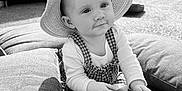 Esmae is registered to the contest to win money with this photo: baby, child, hat, outdoor, sunhat, toy, cushion, grass, play, infant, overalls, curious, happy, sitting, portrait, daylight, nature, face, hands, clothing