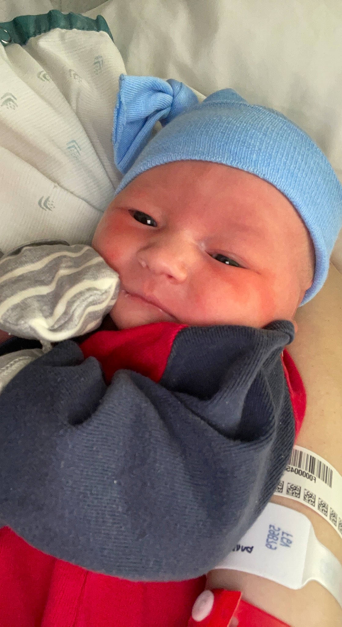 Kyler is registered to the contest to win money with this photo: baby, baby_products, baby_sleeping, baby_toddler_clothing, cap, cheek, child, chin, comfort, electric_blue, facial_expression, happy, headgear, headwear, linens, lip, nose, person, skin, smile