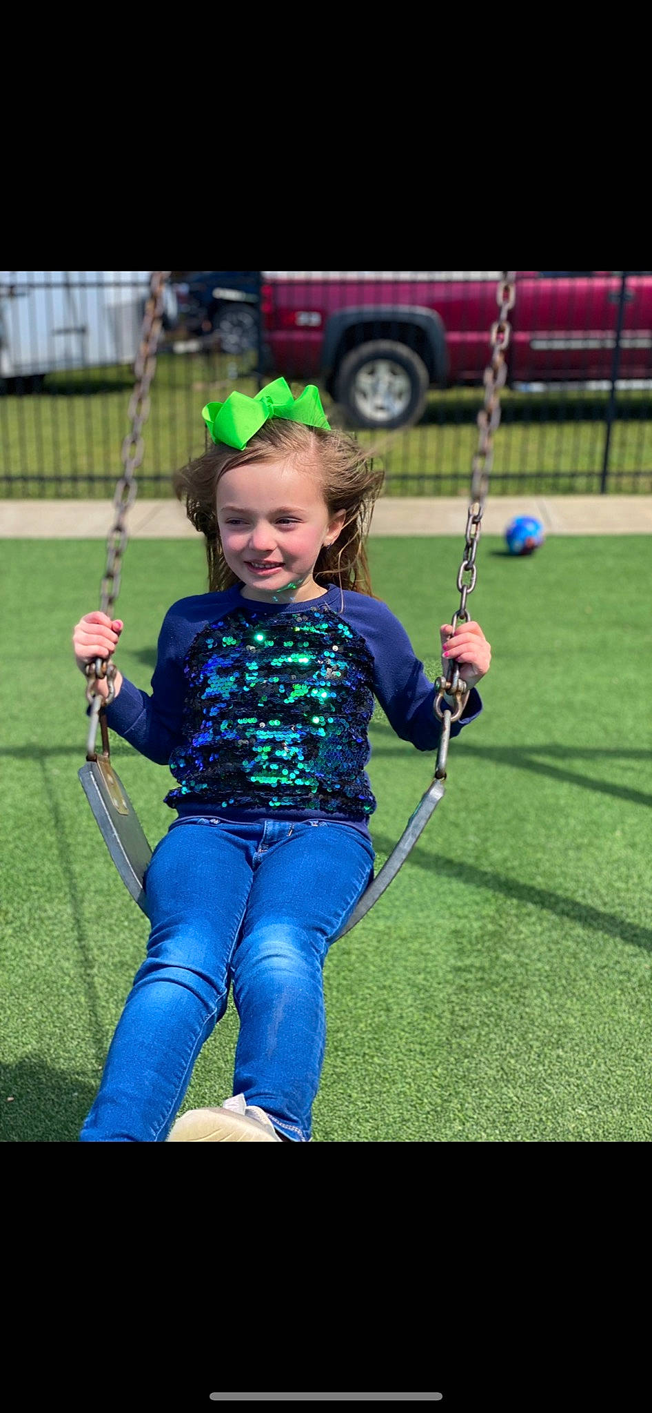 Malaya is registered to the contest to win money with this photo: child, city, electric_blue, face, fun, grass, happy, joy, leg, leisure, outdoor_play_equipment, person, plant, playground, recreation, shorts, smile, swing, t_shirt, tire