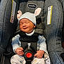 baby, infant, newborn, car_seat, safety_harness, hat, floppy_ears, onesie, pajamas, pacifier, smile, closed_eyes, evenflo_logo, seat_padding, fabric_texture, hands, belt_buckle, indoor, portrait, cute