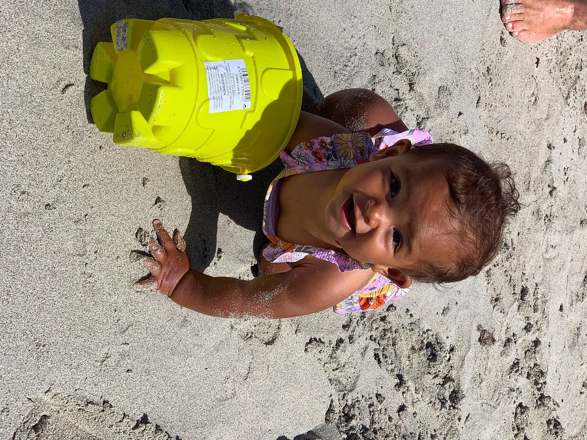 Carmen is registered to the contest to win money with this photo: adaptation, backpack, beach, child, fun, happy, hat, landscape, leisure, people_in_nature, people_on_beach, person, personal_protective_equipment, play, recreation, sand, soil, t_shirt, toddler, travel