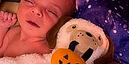 Juniper joined the competition — help win amazing prizes! newborn, baby, infant, sleepy, blanket, plush_toy, halloween, pumpkin, dog_face, bed, bedding, galaxy_pattern, cozy, resting, child, soft_toy, cute, indoor, portrait, closeup