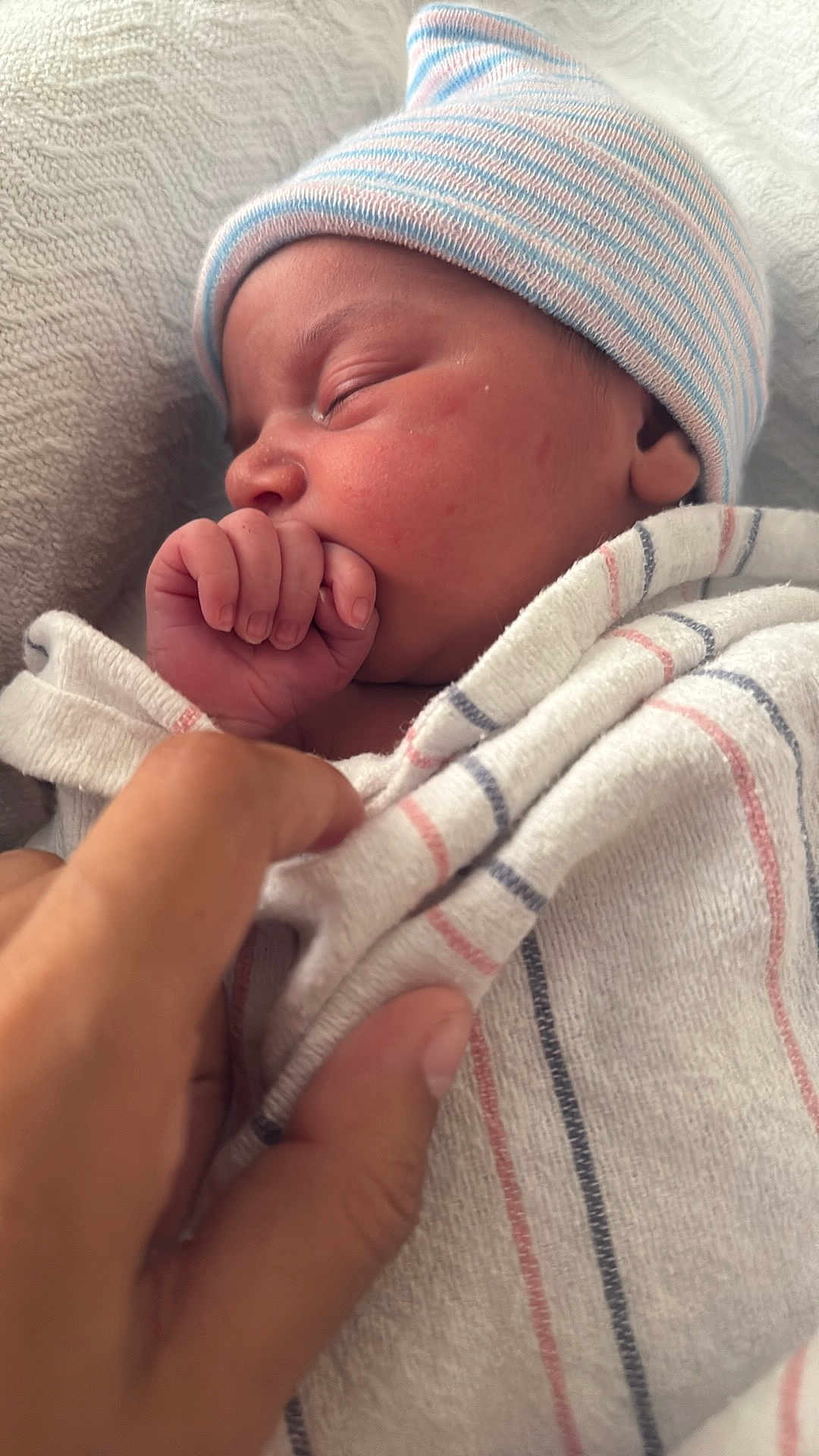 Juniper joined the competition — help win amazing prizes! newborn, baby, sleeping, hand, blanket, hat, striped, wrapped, cozy, infant, skin, person, closeup, peaceful, cute, resting, soft, toddler, portrait, indoors