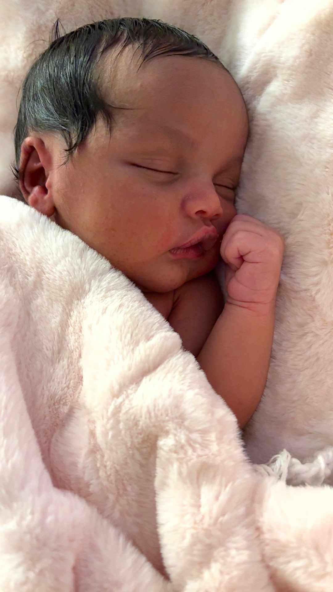 Illy is registered to the contest to win money with this photo: newborn, baby, sleeping, blanket, pink, soft, cozy, infant, face, hand, skin, cute, peaceful, resting, child, portrait, closeup, indoors, warm, comfort