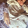 Violet joined the competition — help win amazing prizes! baby, newborn, sleeping, blanket, person, hand, clothing, floral_pattern, comfort, rest, peaceful, soft_texture, indoor, closeup, infant, parent, care, cozy, warm_light, portrait