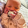 Violet is registered to the contest to win money with this photo: baby, newborn, pacifier, hand, face, sleepy, blanket, clothing, button, infant, cute, soft, closeup, person, skin, bed, resting, indoors, comfort, tiny