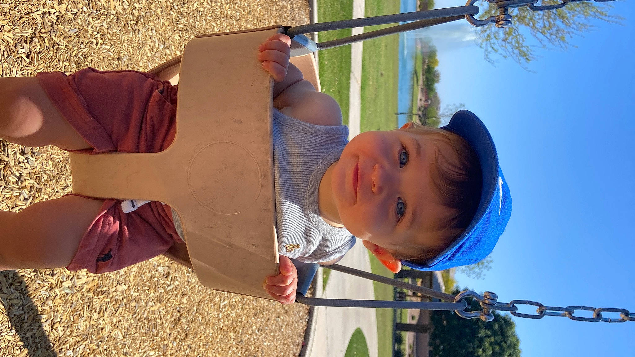 Forrest joined the competition — help win amazing prizes! city, fun, grass, happy, head, headwear, leaf, leisure, light, outdoor_play_equipment, person, plant, public_space, shade, sky, smile, sunlight, t_shirt, toddler, tree