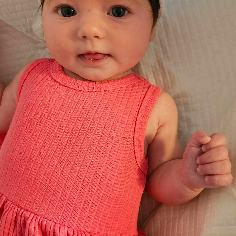 Leysha is registered to the contest to win money with this photo: accessories, baby, barefoot, bodypart, bonnet, clothing, couch, dress, face, finger, furniture, hand, hat, head, headband, homedecor, newborn, person, photography, portrait