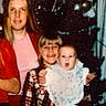 Javari is registered to the contest to win money with this photo: baby, child, christmas_tree, curtain, dress, family, festive, grainy, happy, holiday_decor, indoor, ornament, plaid, portrait, seated, sibling, smiling, toddler, vintage_photo, woman