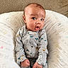 Javari is registered to the contest to win money with this photo: baby, blanket, boppy_pillow, child, cute, expression_surprised, eyes, fabric, fist, hair, hands, indoor, infant, onesie, pattern, pillow, portrait, sitting, skin, sofa