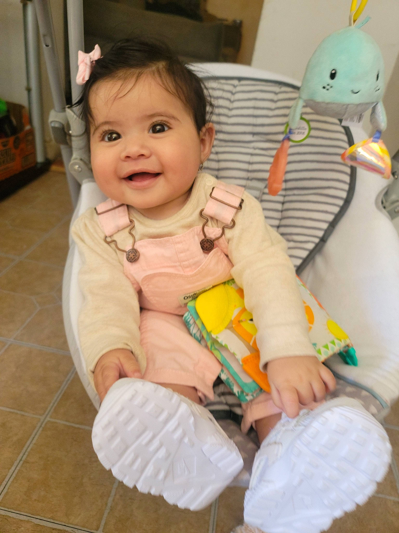 Serena is registered to the contest to win money with this photo: baby, baby_products, baby_toddler_clothing, cheek, child, comfort, eye, finger, flooring, fun, hand, happy, joy, person, room, sitting, skin, smile, stuffed_toy, thumb
