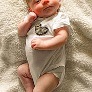 Daxton is registered to the contest to win money with this photo: baby, blanket, child, cozy, cute, expression, face, foot, hand, indoors, infant, lying_down, newborn, onesie, peaceful, portrait, resting, skin, soft_texture, white_clothing