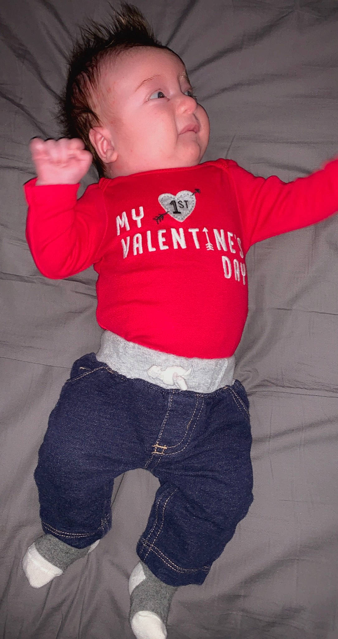 Bronson is registered to the contest to win money with this photo: arm, baby, baby_toddler_clothing, cheek, comfort, elbow, eye, face, finger, gesture, hand, human_body, lip, mouth, neck, nose, person, skin, sleeve, stomach