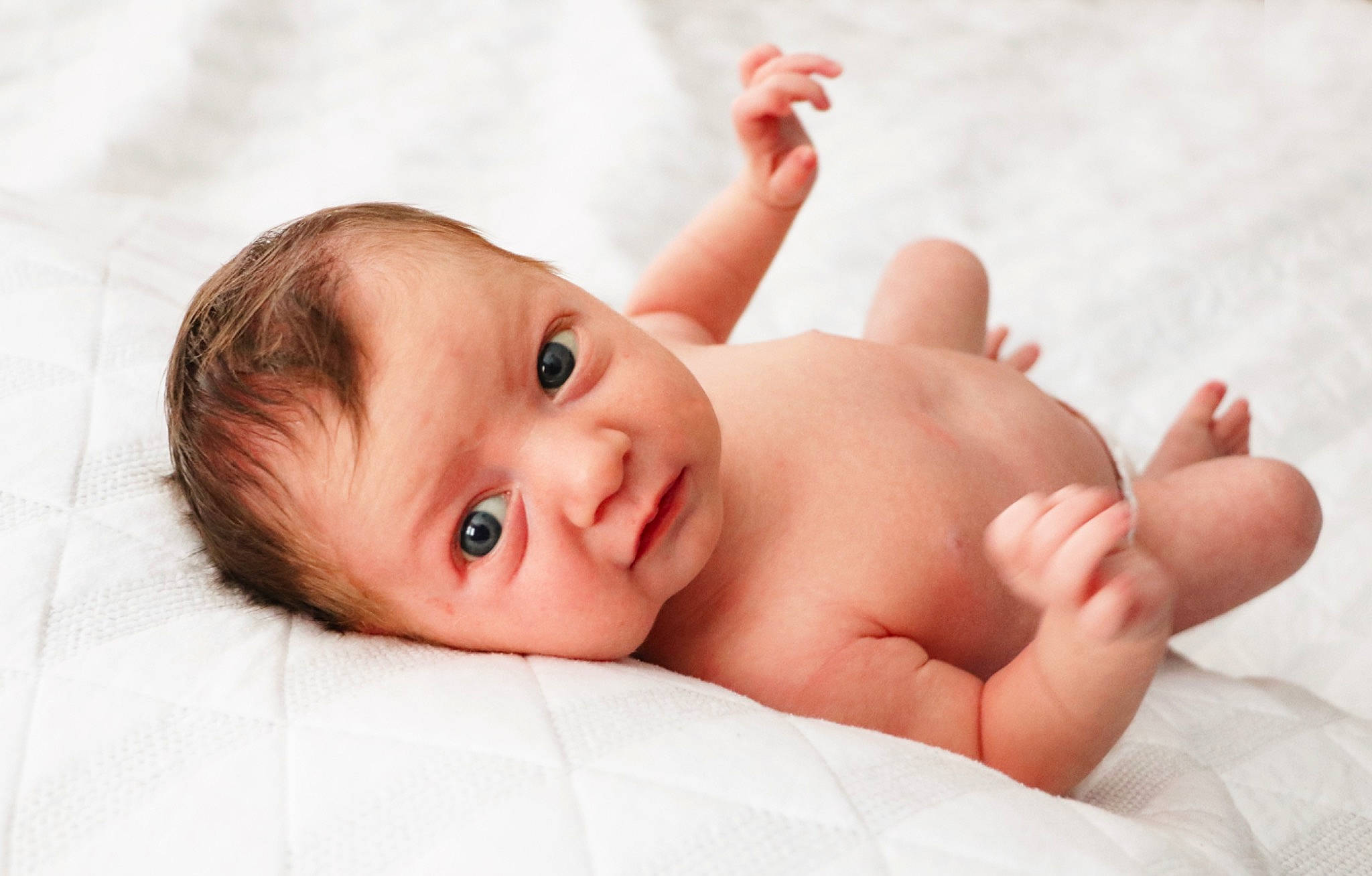 Bronson is registered to the contest to win money with this photo: arm, baby, baby_toddler_clothing, cheek, child, comfort, eye, eyelash, face, foot, happy, linens, lip, nail, nose, person, portrait_photography, skin, stomach, thumb