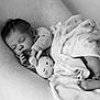 baby, sleeping, blanket, soft_toy, monochrome, infant, cozy, peaceful, cute, child, portrait, rest, toddler, fabric, comfort, relaxation, indoor, face, hand, foot