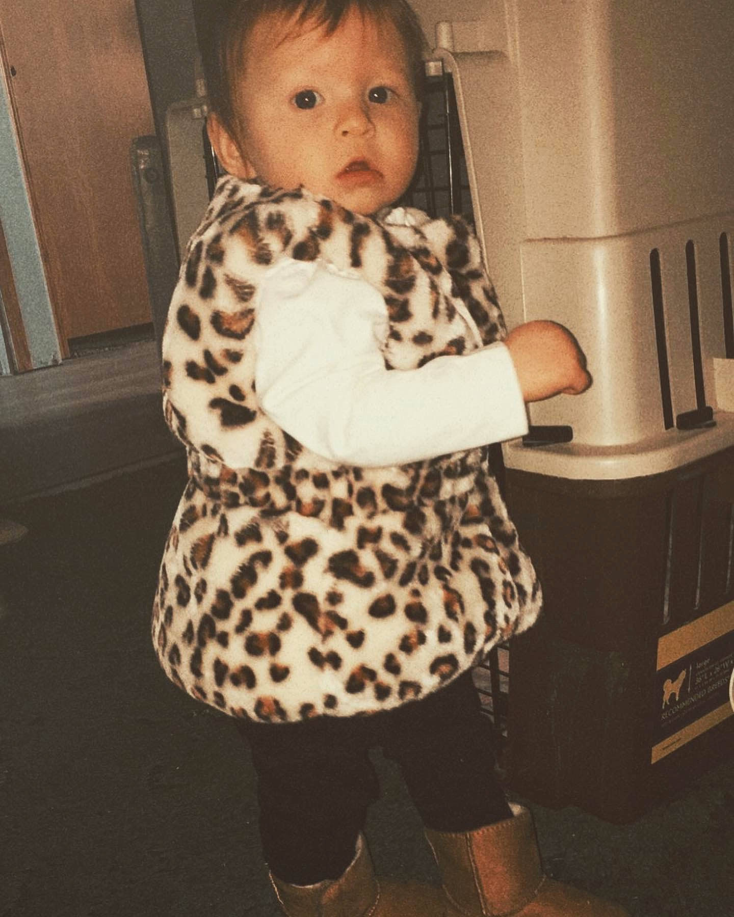 Dalilah is registered to the contest to win money with this photo: baby, baby_products, baby_toddler_clothing, child, eye, flooring, fur, home_appliance, human_leg, knee, monochrome_photography, pattern, person, room, sitting, sleeve, standing, surprise, t_shirt, thigh