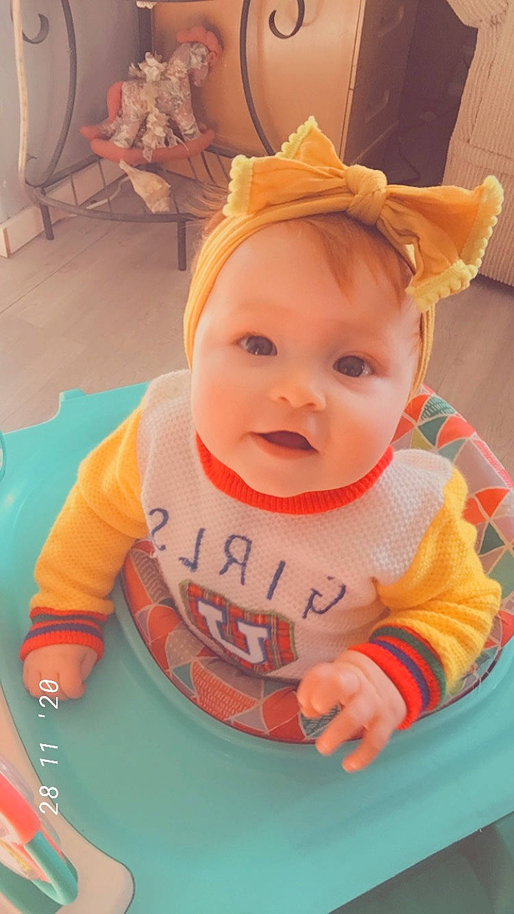 Dalilah is registered to the contest to win money with this photo: baby, baby_products, baby_safety, baby_toddler_clothing, bib, chair, cheek, child, face, fun, happy, iris, orange, person, room, sitting, skin, sleeve, smile, t_shirt