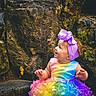 Ellianna is registered to the contest to win money with this photo: baby, child, infant, toddler, portrait, outdoor, forest, rocks, nature, rainbow_dress, tutu, purple_bow, headband, smiling, looking_up, sitting, colorful_clothing, long_sleeves, natural_light, photography