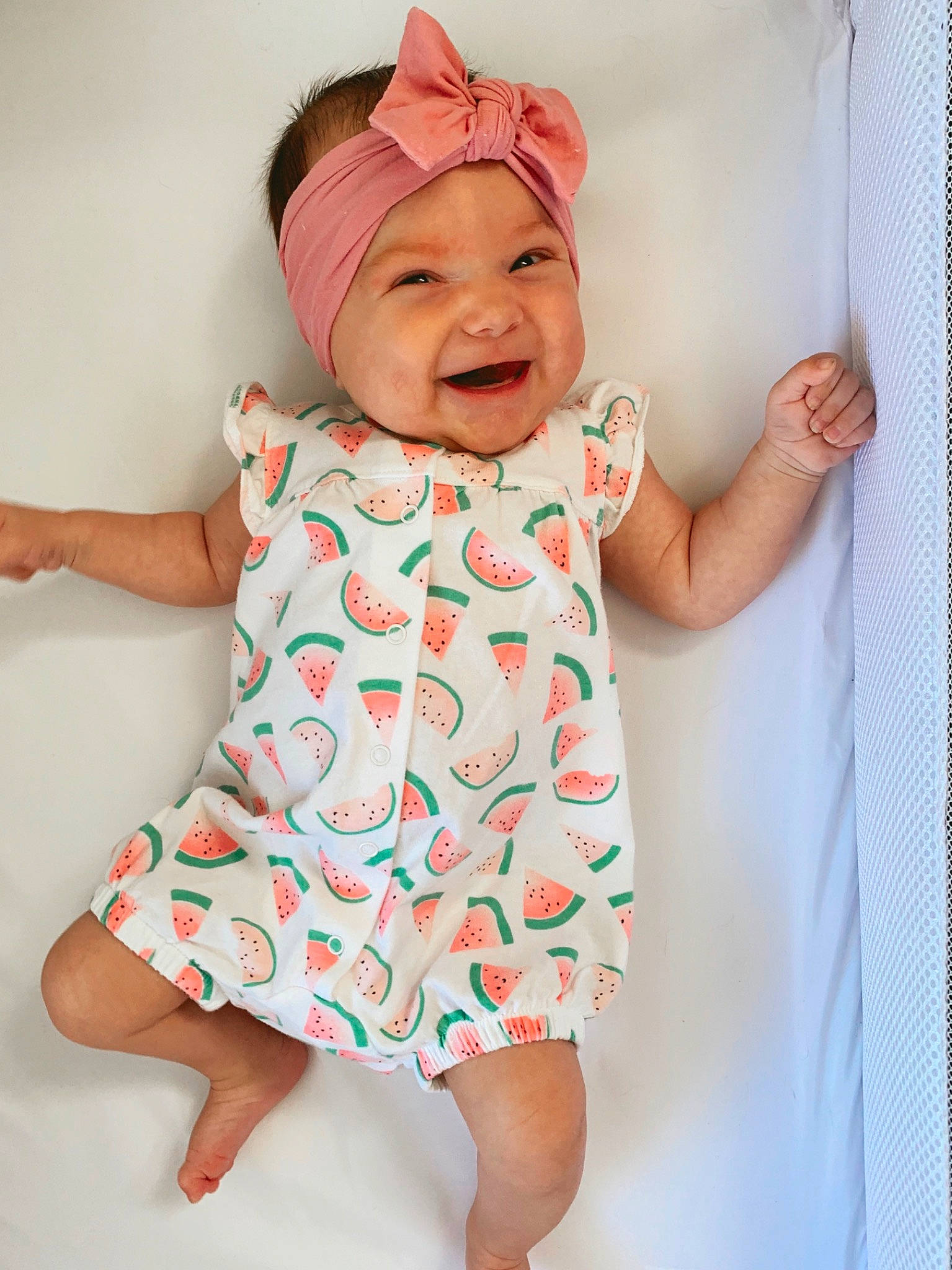 Rowan is registered to the contest to win money with this photo: baby, baby_laughing, baby_products, baby_toddler_clothing, child, design, facial_expression, happy, head, headgear, headwear, joy, pattern, person, pink, product, skin, sleeve, smile, textile