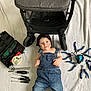 Loris a rejoint le concours — aidez-le/la à gagner de superbes lots ! baby, denim_overalls, bandana, tools, stroller, white_blanket, face, smudged_face, pliers, screwdrivers, wrench, measuring_tape, toolbox, lying_down, indoors, child, cute, blue_jeans, happy, portrait