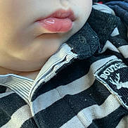 Loris participe au concours pour gagner de l'argent avec cette photo : baby, black_and_white, button, casual, child, chin, close_up, collar, cute, fabric, face_partial, infant, innocence, jacket, lips, portrait, soft_skin, striped_clothing, texture, young_child