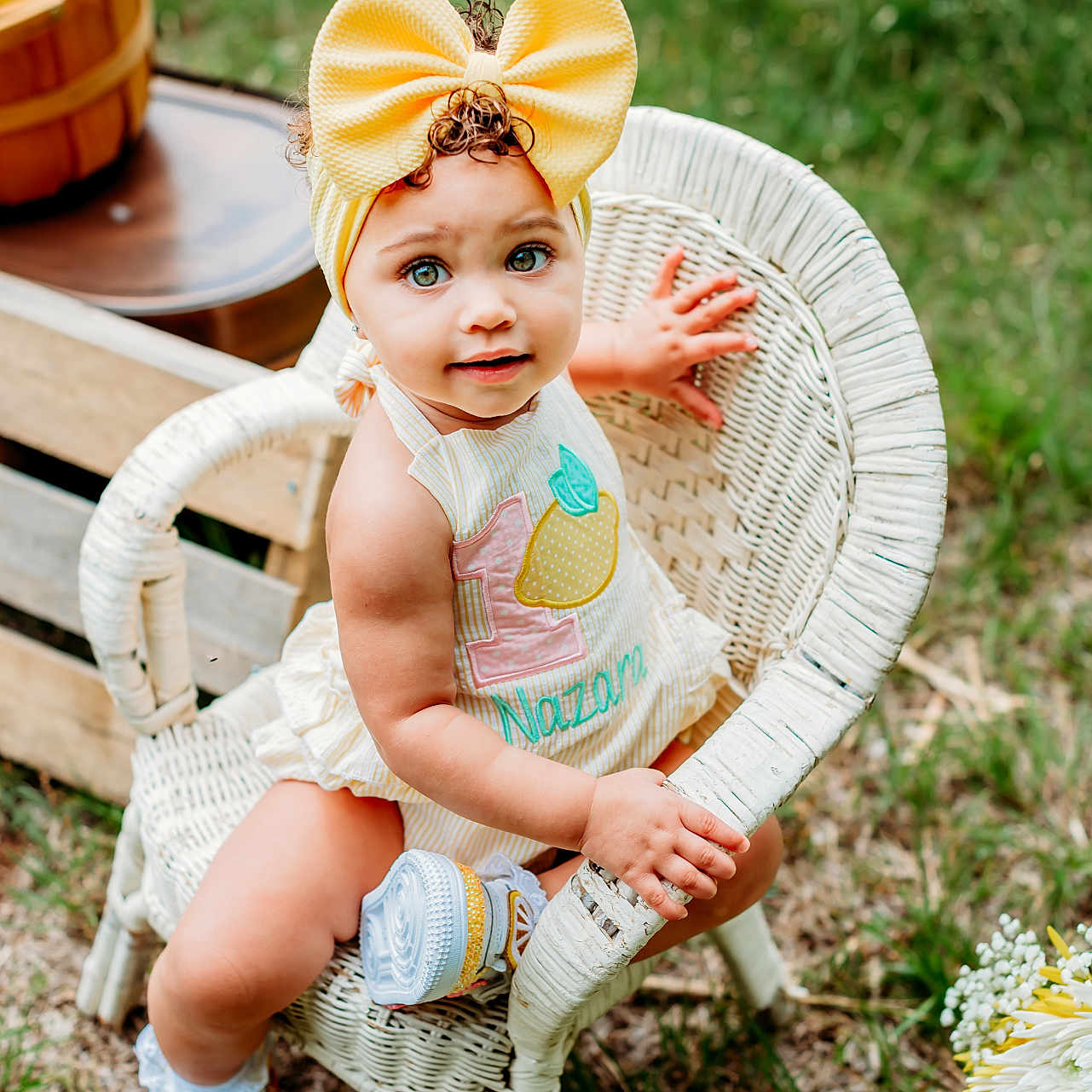 Nazara joined the competition — help win amazing prizes! toddler, child, yellow_bow, headband, wicker_chair, outdoor, grass, lemon, basket, wooden_crate, shoes, cute, portrait, summer, baby, smiling, sitting, nature, clothing, greenery