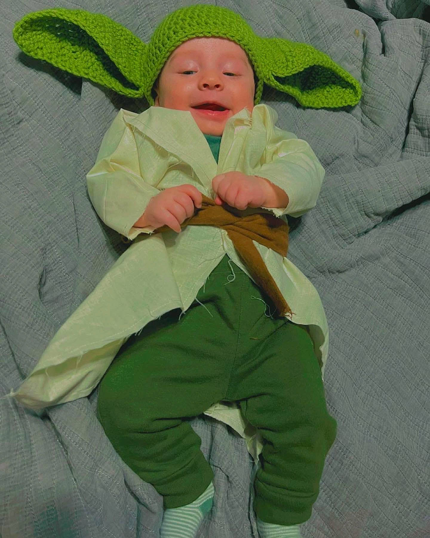 Elijah is registered to the contest to win money with this photo: baby, baby_products, baby_safety, baby_sleeping, baby_toddler_clothing, beanie, bedding, child, comfort, eye, grass, head, headwear, khaki_pants, linens, person, polar_fleece, room, sitting, sleeve