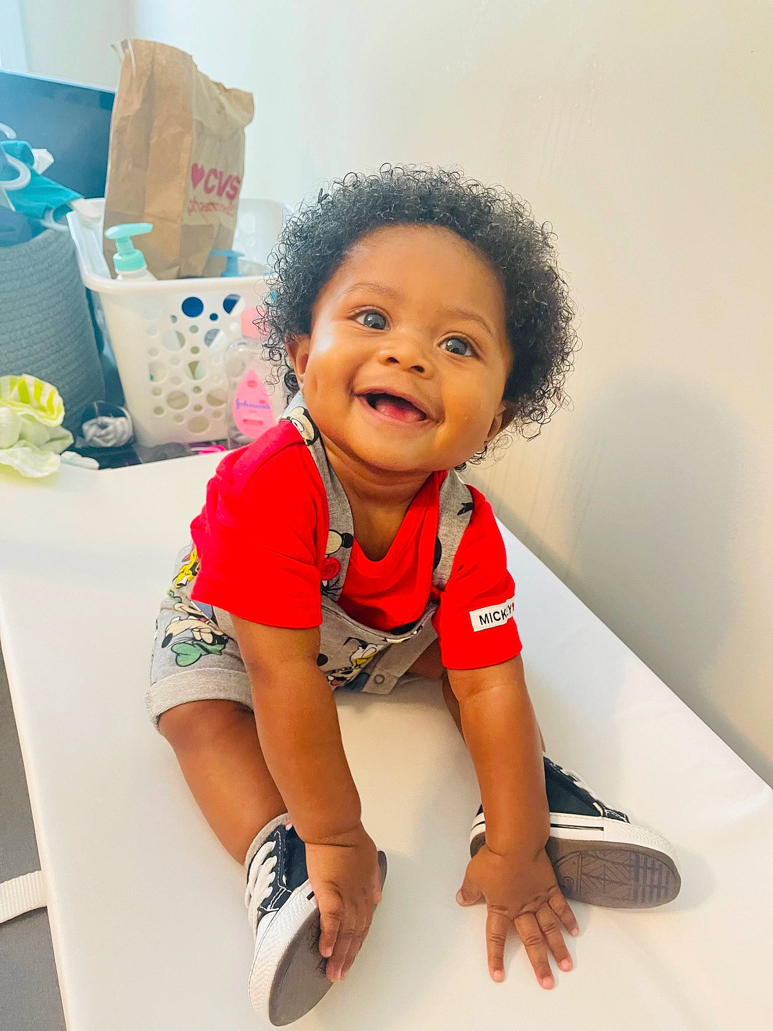 Cannon is registered to the contest to win money with this photo: baby, cheek, child, elbow, flash_photography, flooring, fun, gesture, happy, human_leg, knee, person, room, shipping_box, sitting, sleeve, smile, t_shirt, thigh, toddler