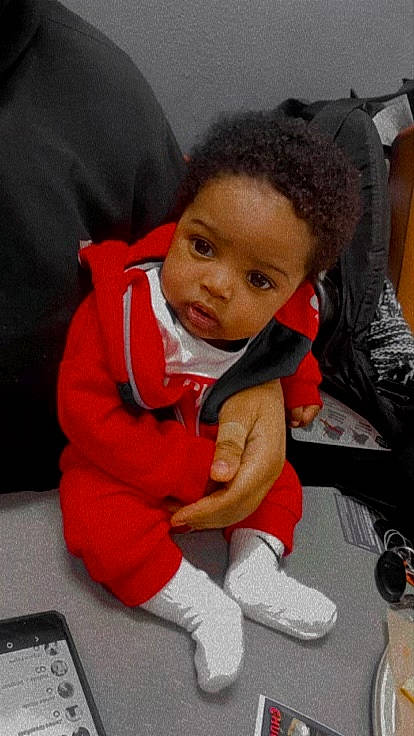 Brayson is registered to the contest to win money with this photo: baby, baby_products, baby_toddler_clothing, carmine, cheek, child, comfort, gadget, lap, person, sitting, sock, toddler, walking_shoe