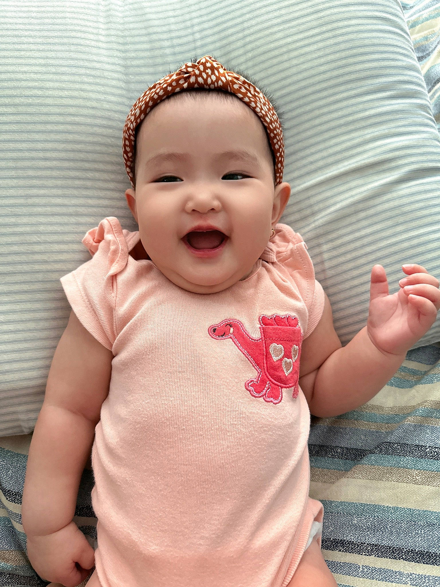 Kim is registered to the contest to win money with this photo: baby, baby_toddler_clothing, cheek, comfort, cool, eye, finger, gesture, hand, happy, head, headwear, iris, lip, mouth, nose, person, pink, skin, sleeve