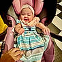 Isabella is registered to the contest to win money with this photo: baby, car_seat, checkered_floor, child, clothing, cute, dress, floor, hand, happy, headband, indoor, infant, person, pink, playful, seat, smiling, socks, striped