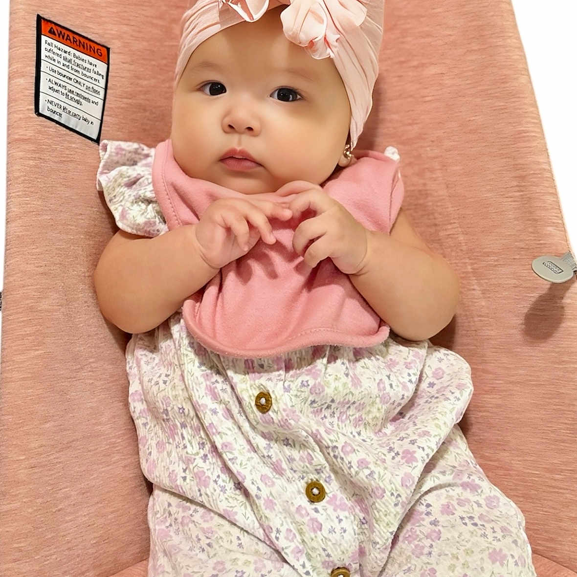 Isabella is registered to the contest to win money with this photo: adorable, baby, baby_seat, bib, child, clothing, comfortable, cute, earrings, expression, face, floral_outfit, hands, headwrap, indoor, infant, pink, portrait, sitting, soft_texture