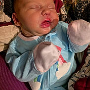 Myla is registered to the contest to win money with this photo: baby, sleeping, onesie, mittens, quilt, blanket, infant, child, cozy, cute, peaceful, portrait, closeup, face, apparel, soft, resting, newborn, indoors, person