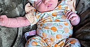 Myla is registered to the contest to win money with this photo: baby, sleeping, infant, headband, pacifier, blanket, soft, plush, clothing, patterned, orange, socks, cute, resting, peaceful, newborn, cozy, portrait, child, indoor
